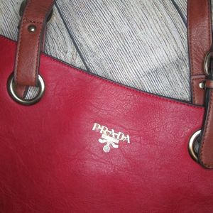 prada marron red acordion bag